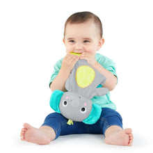 Elephant plush teether held up by baby, teal ears and yellow belly patch