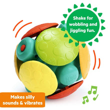 Wobble activity ball toy with green shell, yellow feet, and orange base