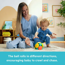 Baby activity wobble ball toy with green and yellow pieces on a play mat