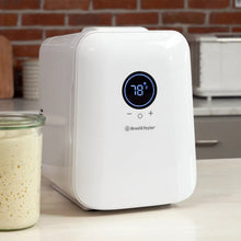 White sourdough home device showing 70°F on digital display beside jar