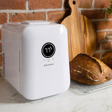 White sourdough home device showing 71°F, beside bread loaf on rack