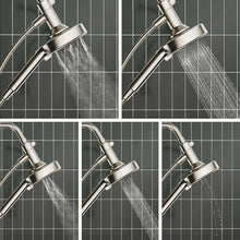 Handheld shower head spraying water from round nozzle face with flexible hose