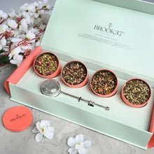 Loose leaf tea gift box with four tins of loose leaf tea and silver infuser