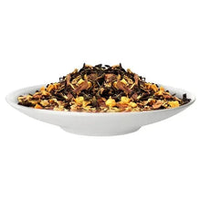 Loose leaf tea in white bowl, dark leaves with golden orange bits