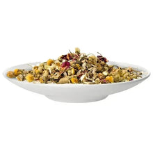 Loose leaf tea in white bowl, green tea leaves with yellow petals and buds