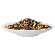Loose leaf tea in white bowl, brown tea leaves with dried botanicals