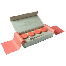 Loose leaf tea gift box, open with four tins and silver plated tea infuser