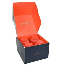 Tea gift box with orange-lidded canisters inside, open top