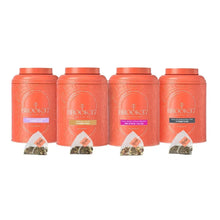 Tea gift tins set with four coral-orange canisters and four tea bags