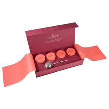 Loose leaf tea giftbox with four small tins and metal tea scoop, open