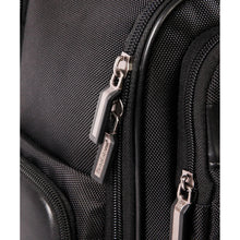 Black backpack with metallic zipper pulls and textured fabric panel
