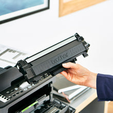 Black toner cartridge held for installation in a printer
