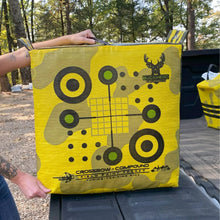 Yellow crossbow compound archery target bag held up, showing large crosshair grid and bullseyes