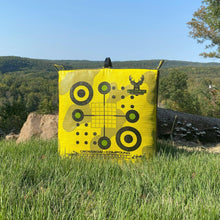 Yellow crossbow compound archery target bag with crosshair bullseye graphic, outdoors