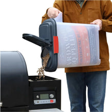 Pellet storage dispenser with side chute and hinged top, shown being filled.