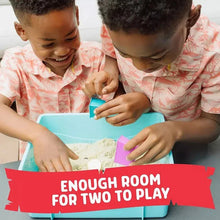 Two children playing together in a blue sensory sand bin with toy molds and sand