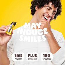Person holding a protein bar wrapper; branding and nutrition highlights visible