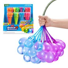 Self-sealing water balloon bunch in purple and blue, held by a hand
