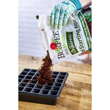 Burpee organic seed starting mix bag tipped over seed trays with soil