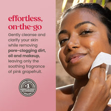 Woman cleaning her face with a white cleansing wipe