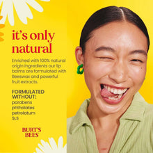 Smiling woman with lip balm on lips, yellow tint