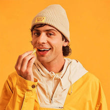 Man applying yellow lip balm from a capped stick