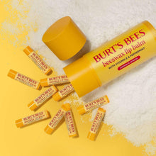 Lip balm assortment with multiple yellow tubes and open caps