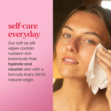Woman wiping face with a white micellar facial towelette
