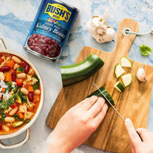 Bush's Best dark red kidney beans can beside fresh vegetables and a cooked dish