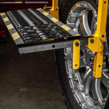 CAT deluxe tire service step beside truck wheel with black textured stepping surface