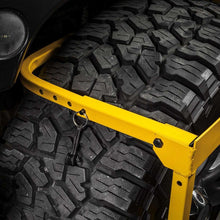 CAT tire service step with black traction mat on yellow support frame