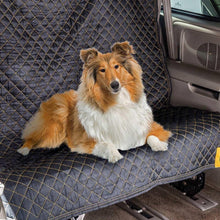 Quilted utility blanket covering a car seat, dark navy with yellow stitching and CAT logo patches
