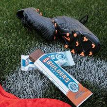 CLIF BUILDERS protein bars on grass with bar wrappers, 20g per bar
