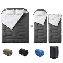 Dark gray double sleeping bag with fold-and-store panels and two pillows on top