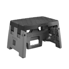 Plastic folding step stool, black top and gray base, textured standing platform