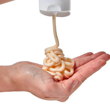 Ceramide hair treatment cream being dispensed into hands