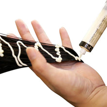 Ceramide hair treatment applied to dark hair strands with squeeze tube