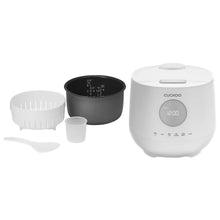 White CUCKOO rice cooker with removable inner parts, measuring cup, and steam basket