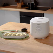 White CUCKOO 6-cup rice cooker on countertop with lid closed