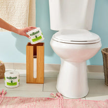 Caboo bamboo bath tissue roll and pack on bathroom floor, Tree Free TP