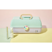 Mint hard-shell vanity case with top handle and round logo badge