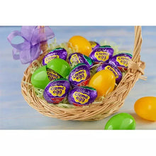 Basket of wrapped chocolate creme Easter candy eggs in green and purple wrappers