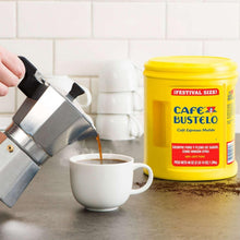 Ground coffee canister with coffee stream pouring into white espresso cup