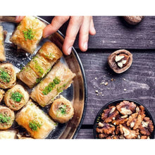 Walnuts and walnut pieces sprinkled over bread slices with a bowl of walnuts