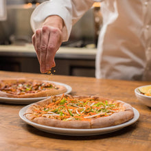 California Pizza Kitchen pizza with veggie toppings on a plate