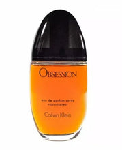 Calvin Klein Obsession eau de parfum spray bottle with black cap, amber orange liquid