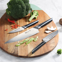 Cangshan Max knife and shears set with 5 stainless pieces on a cutting board