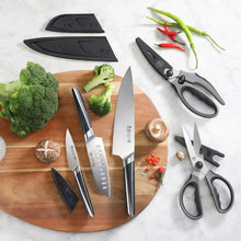 5-piece knife and shears set with silver blades and dark handles, arranged on a board