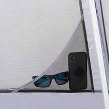 Mesh window panel with a black mesh pocket and small items