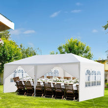 White pop up canopy tent with windowed sidewalls and open seating area with chairs